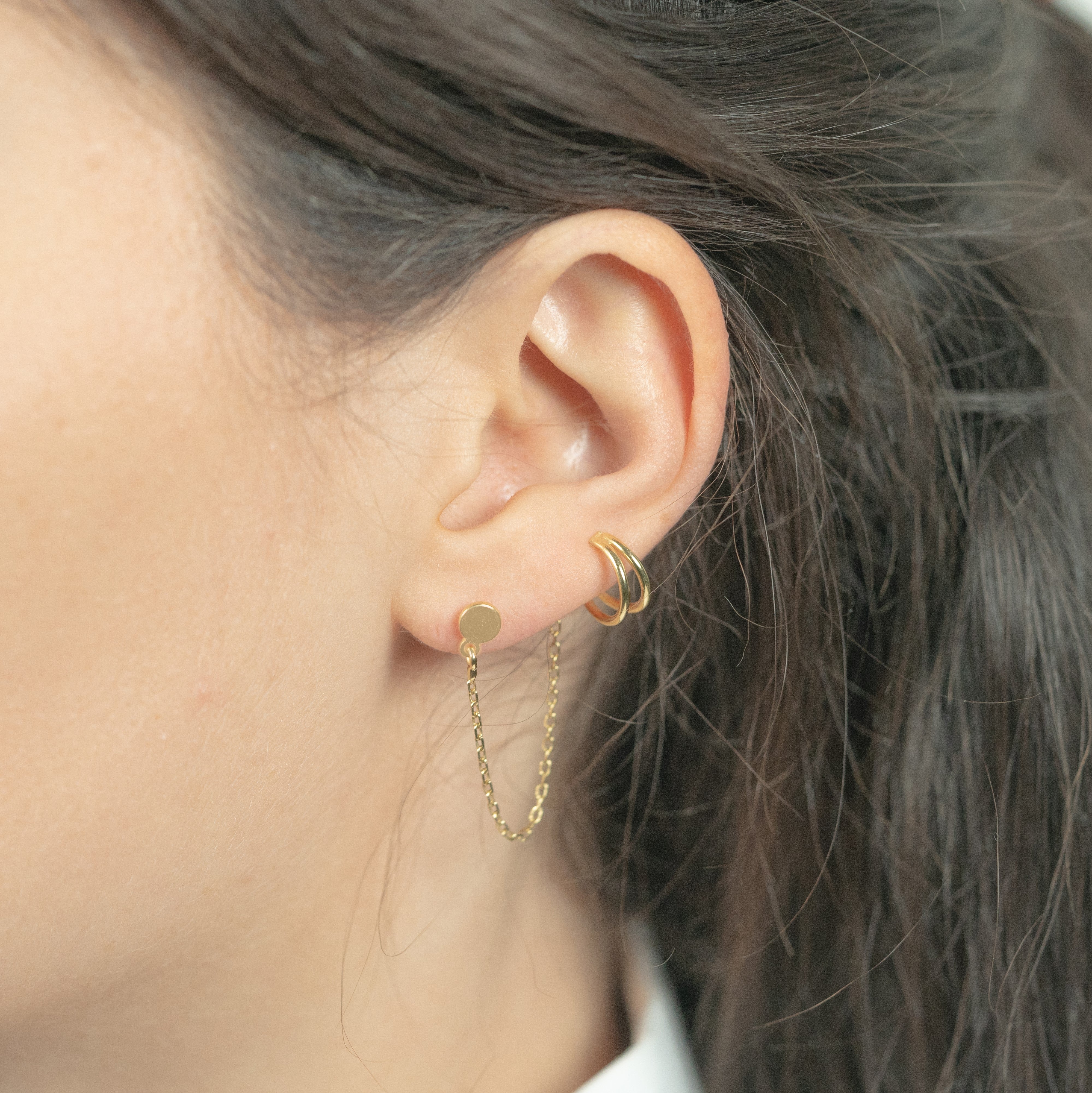 Gold ear cuff earrings worn as ear pendants