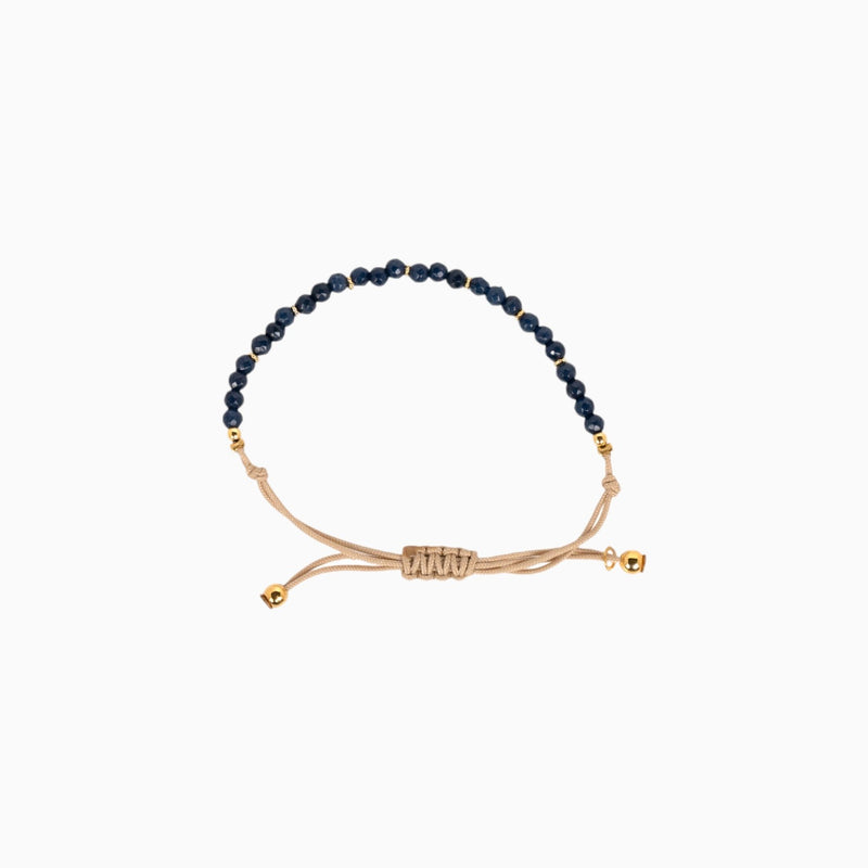 Bracelet en coton beige avec des pierres bleues marines
